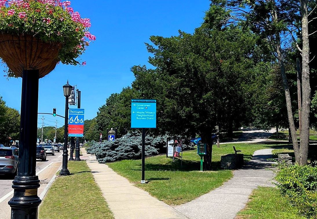 Image of sky blue wayfinding sign with white text.